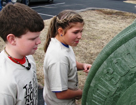 Sedalia Elementary fourth graders Seth Thomas and Bailey Cartwright grimace as they get a whiff of their class&rsquo; compost bin 