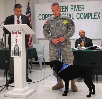 Sgt. James Dennis accepts Harley. Warden Randy White at left, Justice Sec. Brown at right